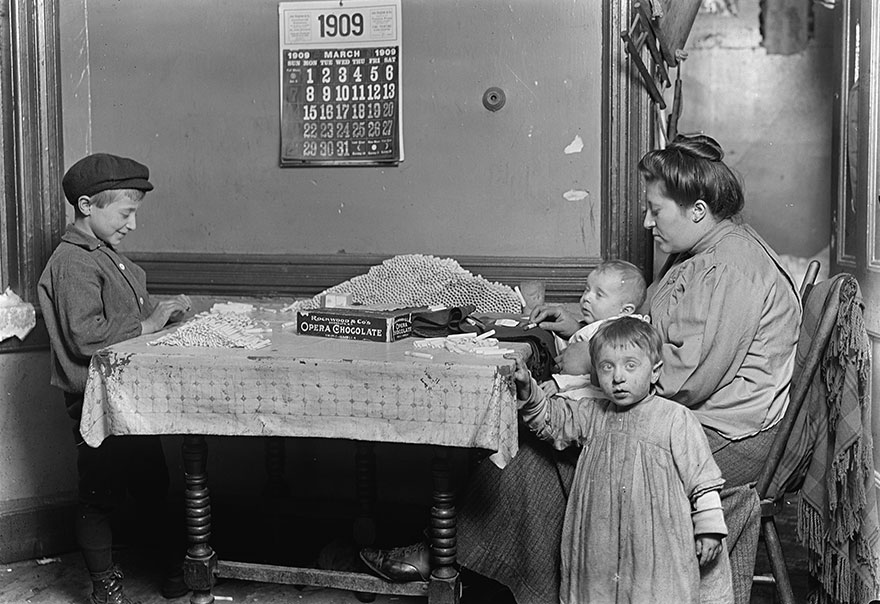 Widow & Boy Rolling Papers For Cigarettes In A Dirty N.y. Tenement. Location: New York, New York