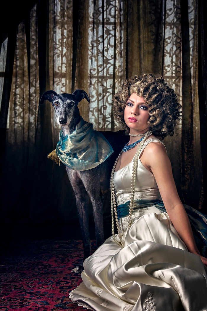 Portrait of a woman with an abandoned hunting dog in Spain, showcasing their bond through artistic photography.
