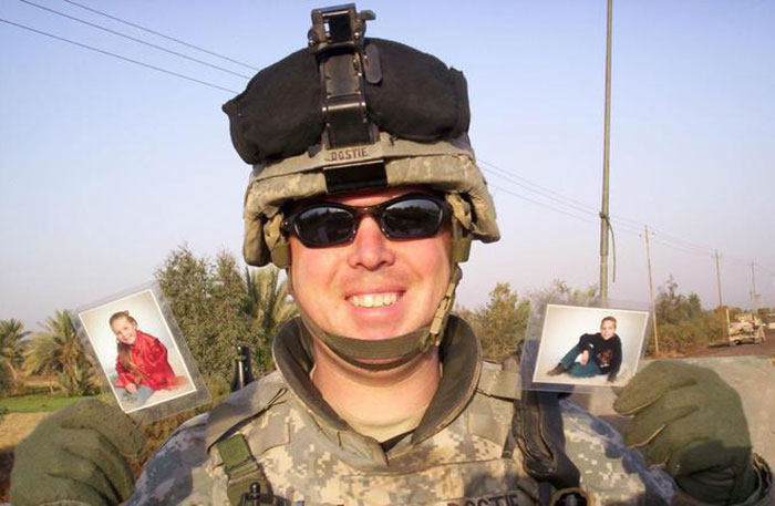 My Father, SFC Shawn Dostie, Holding Up Pictures Of My Sister And I 