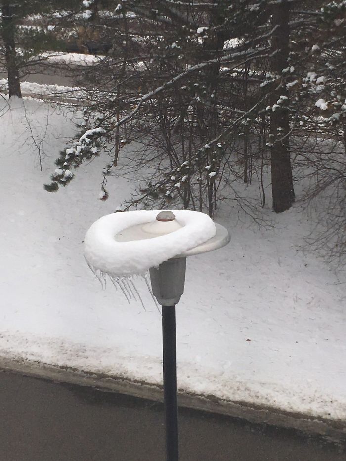 The Wind Shifted The Snow On Top Of This Street Lamp