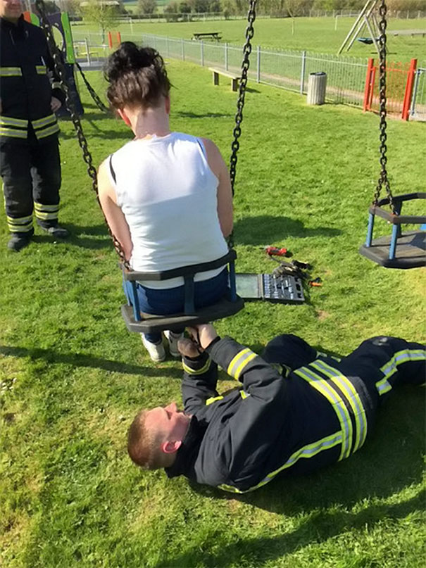 Firefighter Rescuing A Teenager After She Got Stuck In A Baby Swing