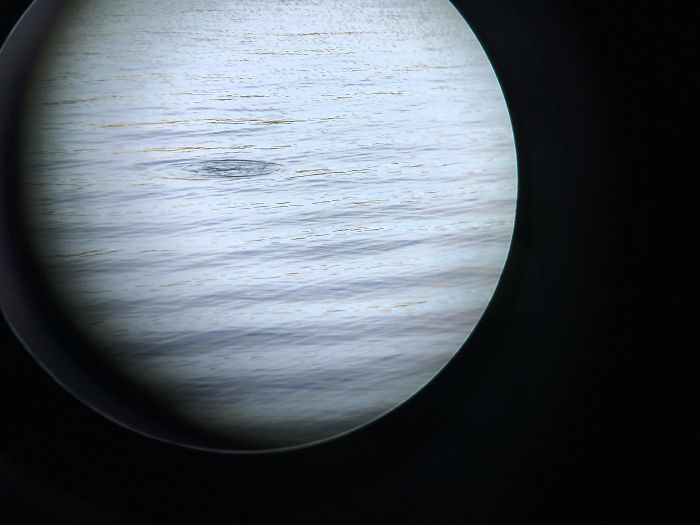 Foto de un lago a través de los prismáticos que parece un planeta