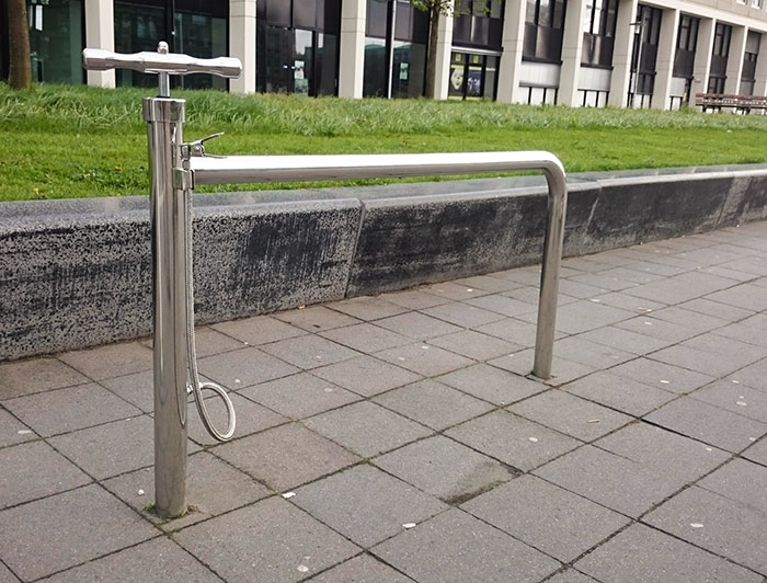 A Public Bike Stand With A Built-In Pump