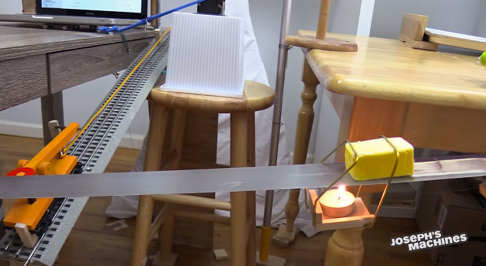 Guy Builds And Films A Chain-Reaction Machine In His Dining Room And You Won't Believe It's Not Edited