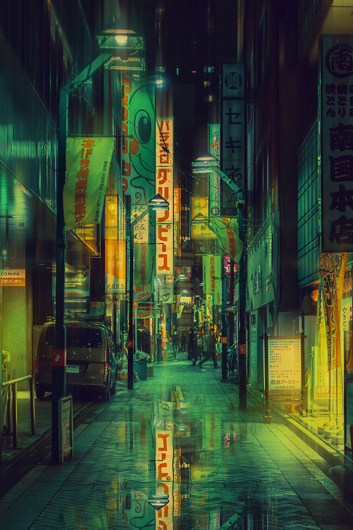 Tokyo street at night with vibrant illuminated signs and reflections showcasing dream trip photography.