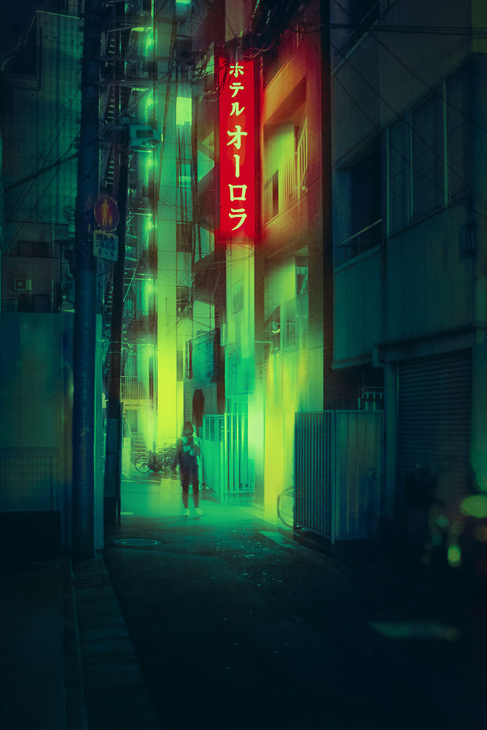 Moody nighttime Tokyo street with glowing neon signs and a person walking, captured on dream trip photography.
