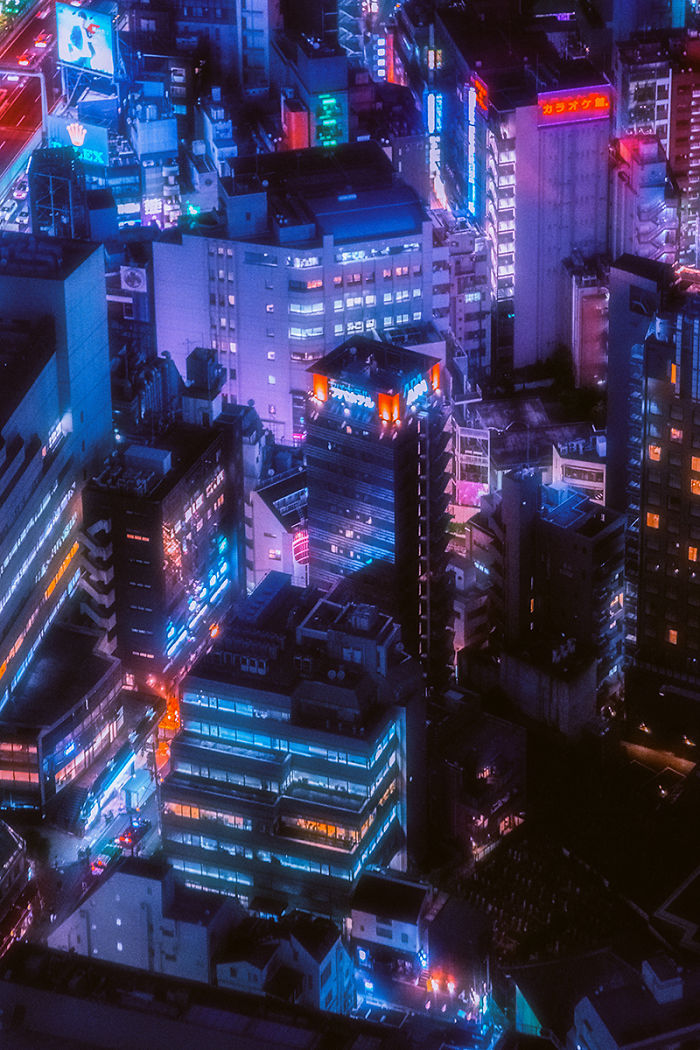 Tokyo cityscape at night glowing with colorful neon lights and illuminated buildings from a dream trip camera perspective.