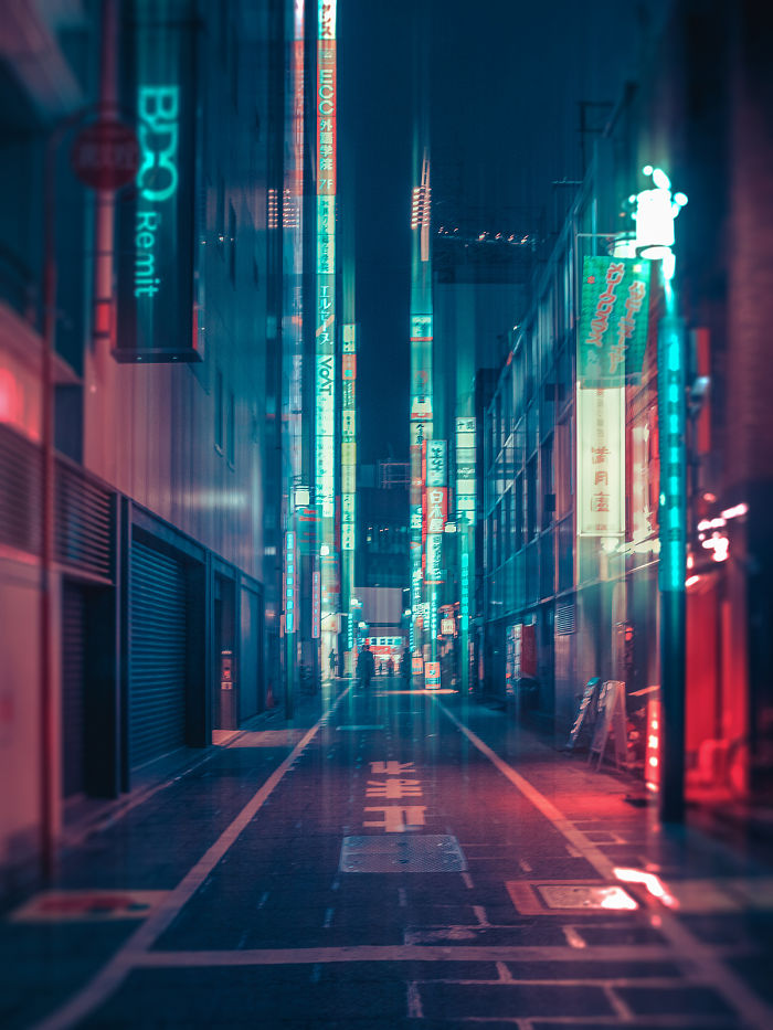 Neon-lit Tokyo street at night with vibrant signs and a lone figure, captured on dream trip photography.