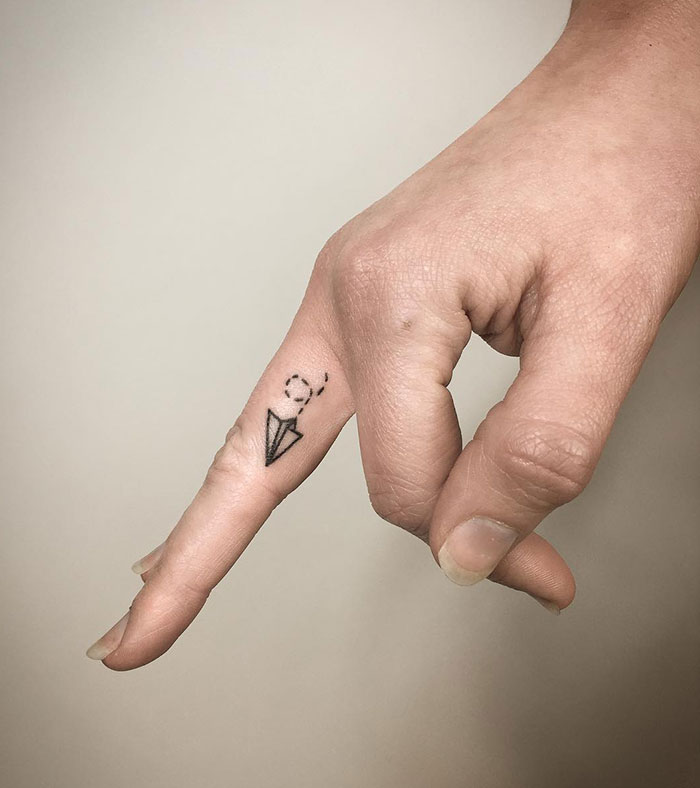 Hand-Poked Paper Plane Finger Tattoo