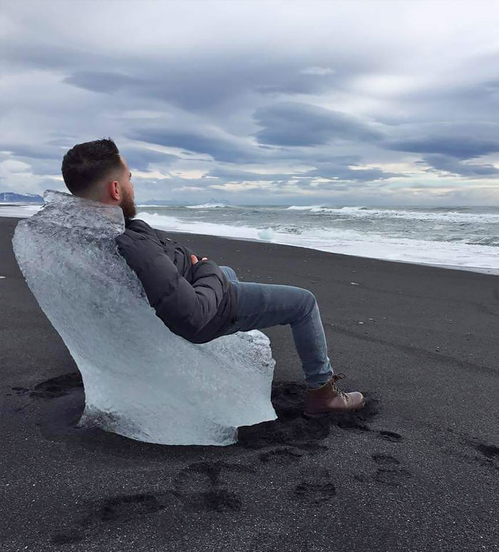 A Sea Weathered Chunk Of Glacial Ice Made A Perfect Chair On A Black Sand Beach In Iceland