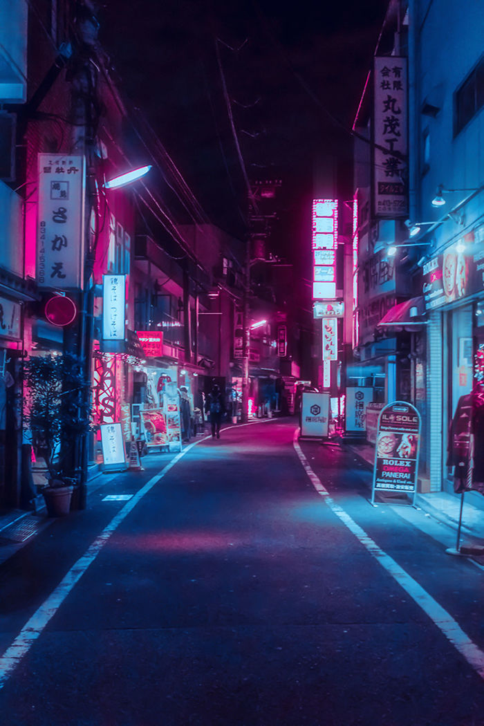 Neon-lit narrow Tokyo street at night with glowing signs and a few pedestrians on a dream trip.