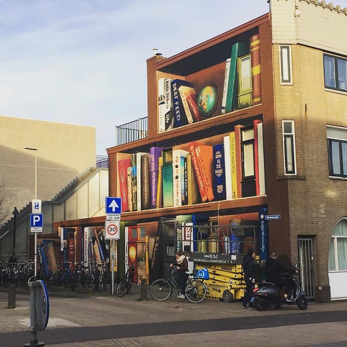 Dutch Artists Paint Giant Bookcase On An Apartment Building Featuring Residents' Favorite Books