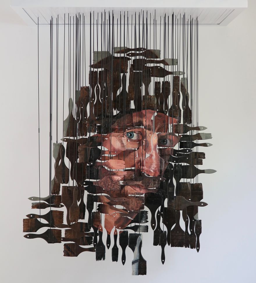 Andrew Myers Creates Art Using Hundreds Of Paint Brushes, Each One Painted With Oil Paint To Create A Self-Portrait. Each Individual Paint Brush Is Suspended By Stainless Steel Rods Attached To A Metal Frame. The Paintbrushes Line Up In Space To Create The Image When Seen Straight On, And Disappears As You Walk Around It.