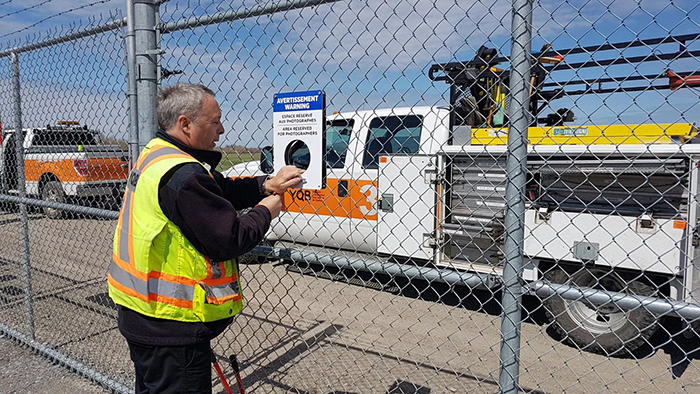 To Help Planespotting Photographers Get Shots, This Airport In Canada Had Holes Cut Out In Their Fence