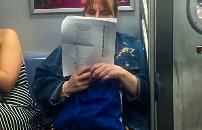 A Woman On The Subway Printed Out 15 Pages Of Facebook Posts And Is Just Reading The Comments