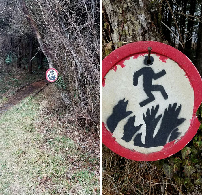 Sign I Found In The Woods That Depicts A Man Jumping Over Some Scary Looking Hands