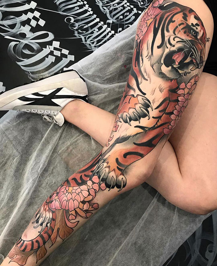 Tiger with flowers leg sleeve tattoo