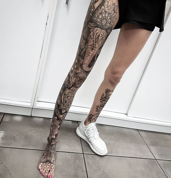 Mandala with elephant and flowers leg sleeve tattoo