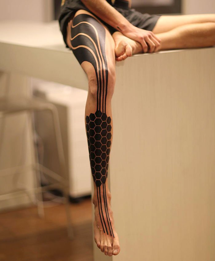 Geometrical and lines leg tattoo