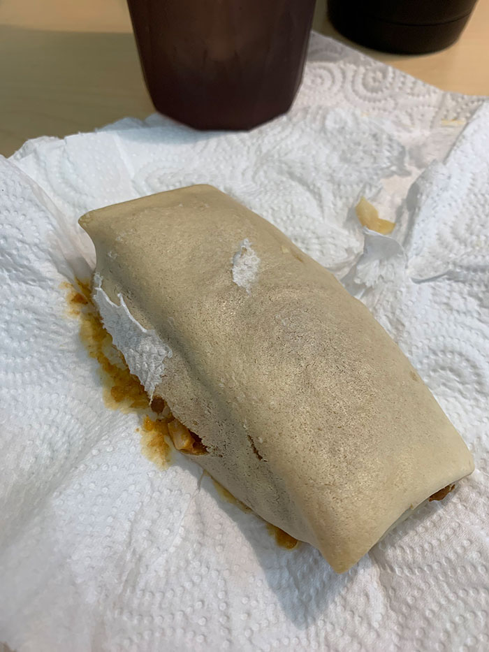 Vegan Gluten Free Burrito With Paper Towel Stuck To It