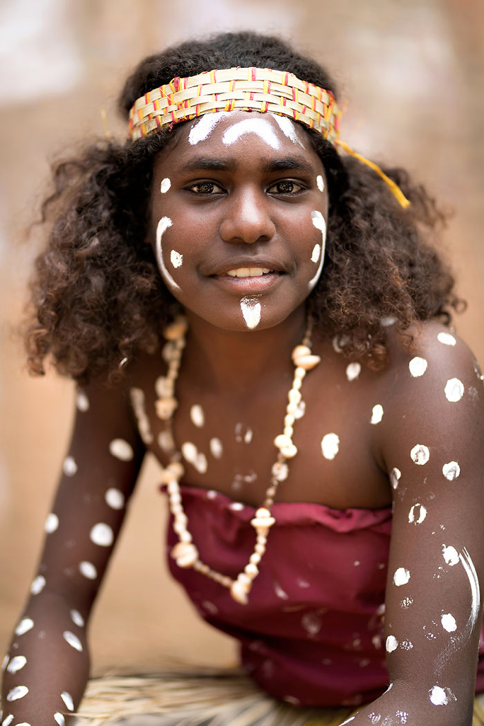 Indigenous person with traditional face paint and headband, photographed in an inaccessible corner of the world.