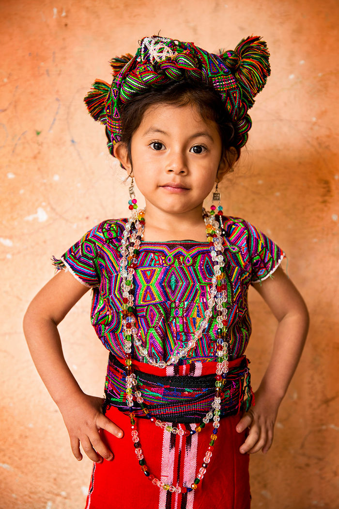 Young indigenous girl wearing traditional colorful clothing and jewelry in an inaccessible corner of the world