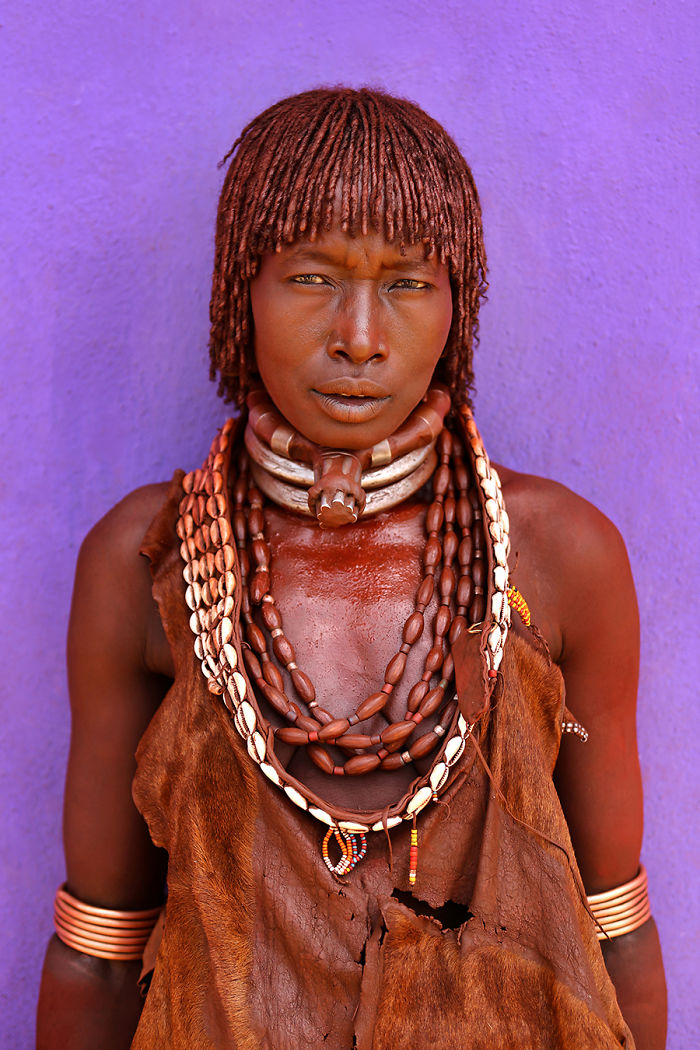 Portrait of an indigenous person wearing traditional jewelry and attire, photographed in inaccessible corners of the world.