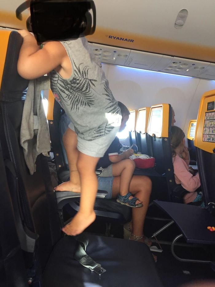 Spotted This Kid Next To Me Jumping And Climbing On His Seat While The Plane Was Landing. Parents, Please