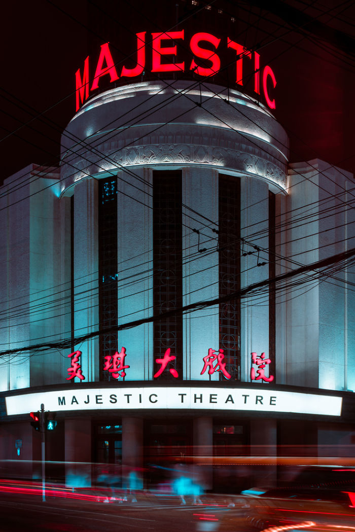 Majestic Theatre building at night with neon lights and blurred motion in a historic Shikumen lane house district in Shanghai.