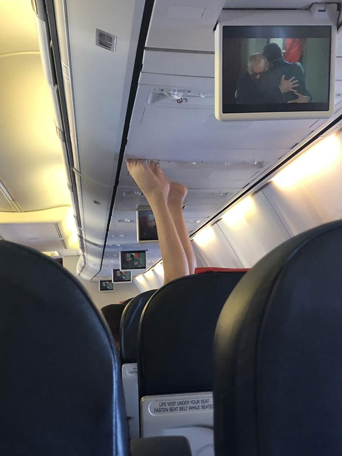 Woman Puts Her Nasty Feet On Airplane Ceiling Where Air Conditioning Is