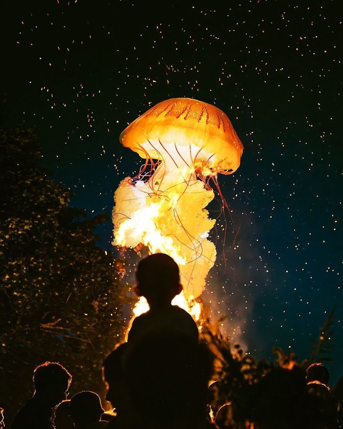 Dreamlike atmosphere with a glowing jellyfish floating above a bonfire and silhouetted people in awe.