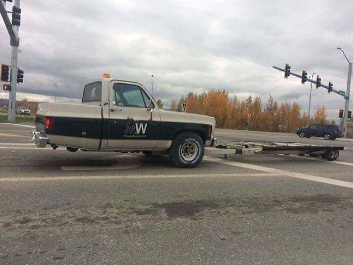 What Is This Weird Half Truck And Why Is It Pushing A Flatbed Trailer? Is There Any Sort Of Advantage Of Pushing Rather Than Pulling It?