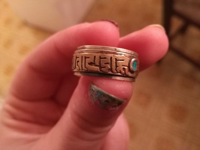 A Ring My Sister Picked Up Of The Ground In The Woods, The Writing Is All Around It And There Are Two Pool-Green Jewels On Either Side. Anyone Have Any Idea What The Symbols Mean?