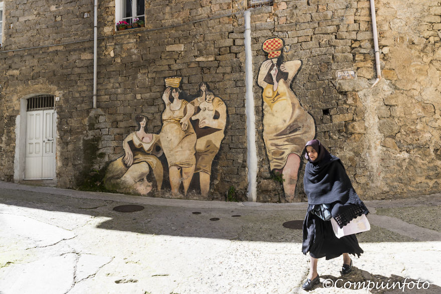 Woman Walking For The Murales In Orgosolo On The Italian Island Of Sardinia