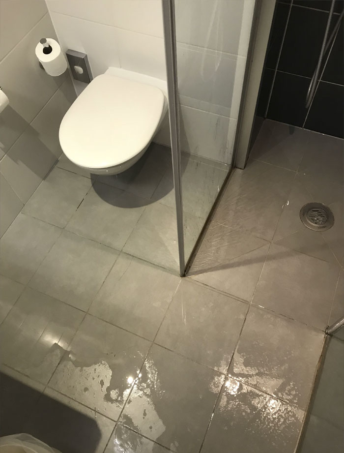 A Shower With No Base And A Crappy Seal + A Floor That Slopes Away From The Drain = A Metric F**kton Of Standing Water Everywhere Except The Shower