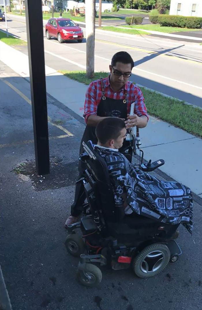 A Guy In A Wheelchair Couldn't Get Through The Doors Of The Barbershop, So The Barber Took His Tools And Gave Him A Haircut On The Street