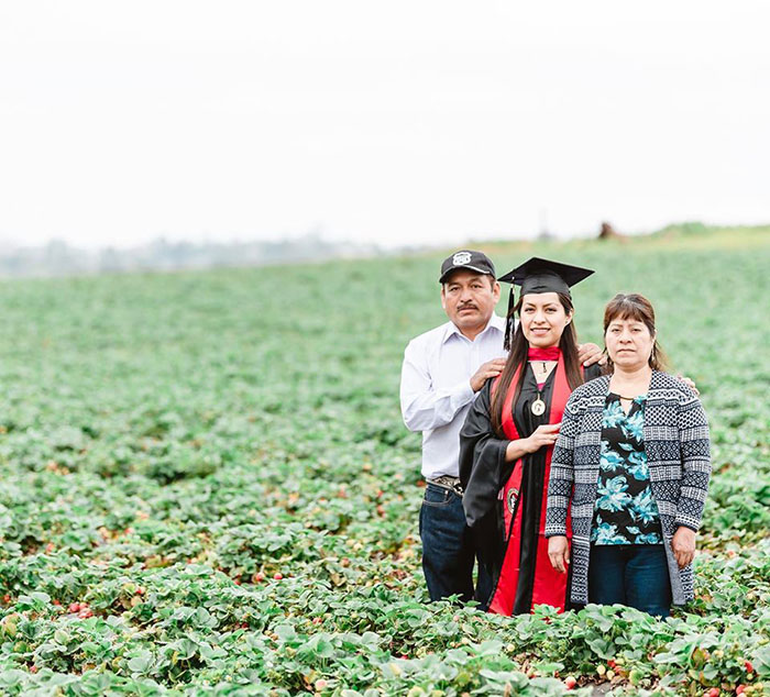 Graduate Takes Powerful Photo With Parents In The Fruit Field They Worked In To Give Her A Better Future
