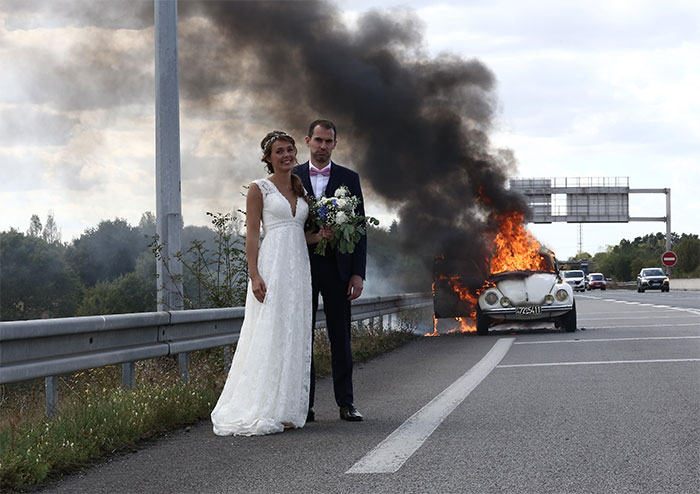 Just Married Couple In Front Of Their Burning Car
