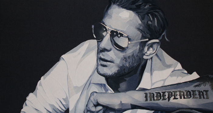 Realistic celebrity portrait in shades of blue showing a man with sunglasses and tattoo, created using denim fabric art.