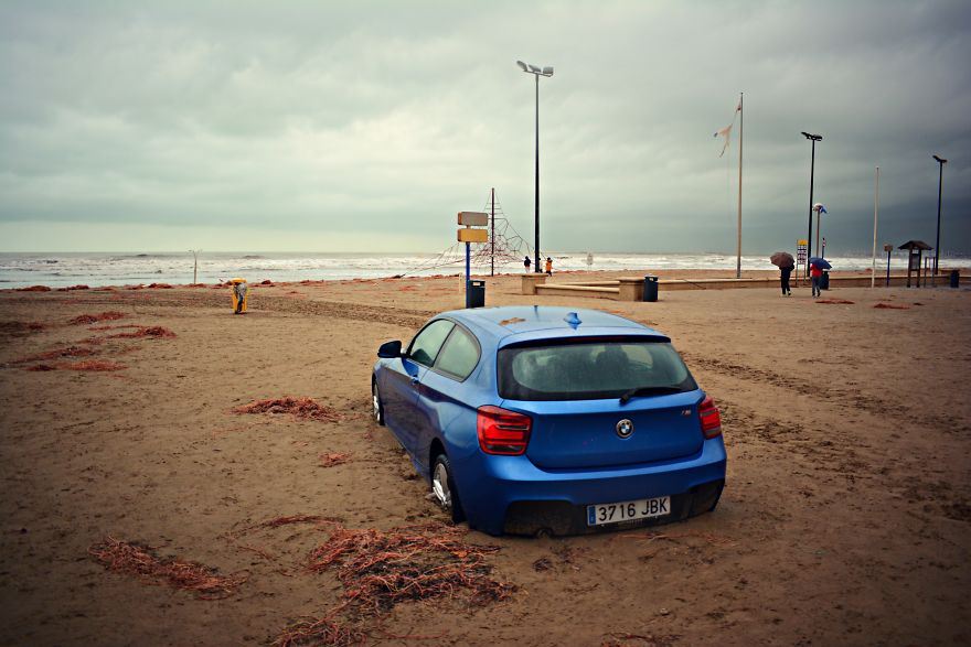 A Car Washed Away From A Car Park Onto The Beach