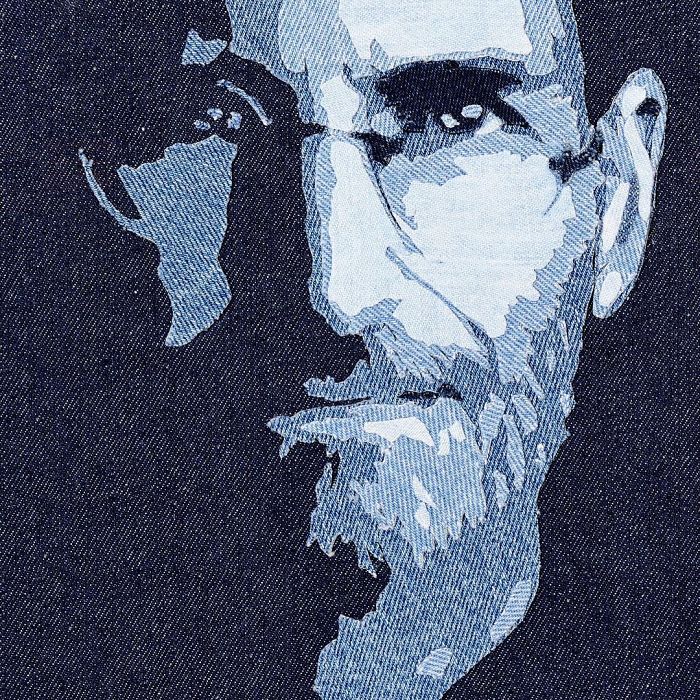 Realistic celebrity portrait created using various shades of denim fabric by Ian Berry, highlighting detailed facial features.