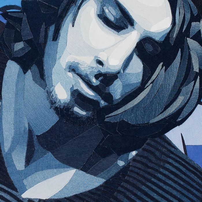 Close-up of a realistic celebrity portrait created with layered denim fabric showcasing detailed texture and shading.