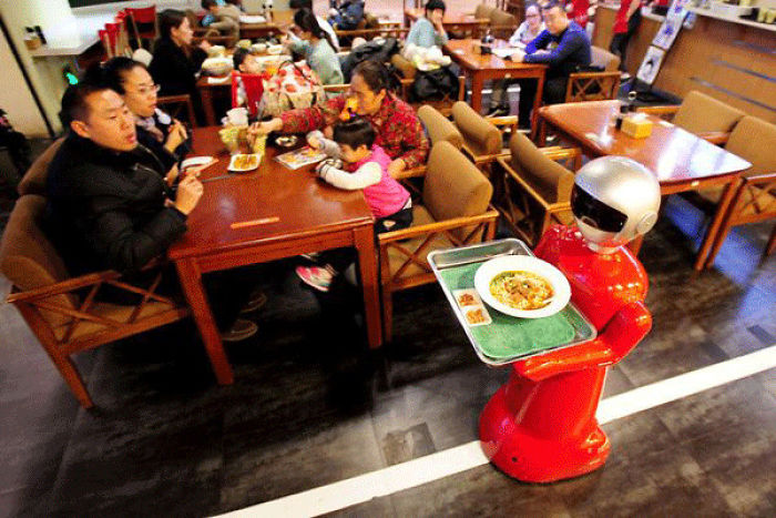 Robot Waiter Serves In Chinese Restaurant