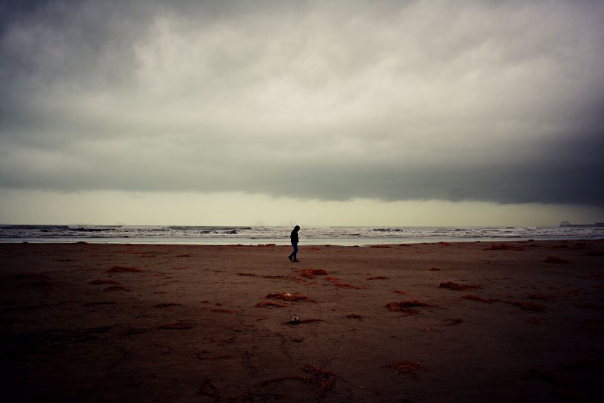 A Lonely Figure Wanders The Beach