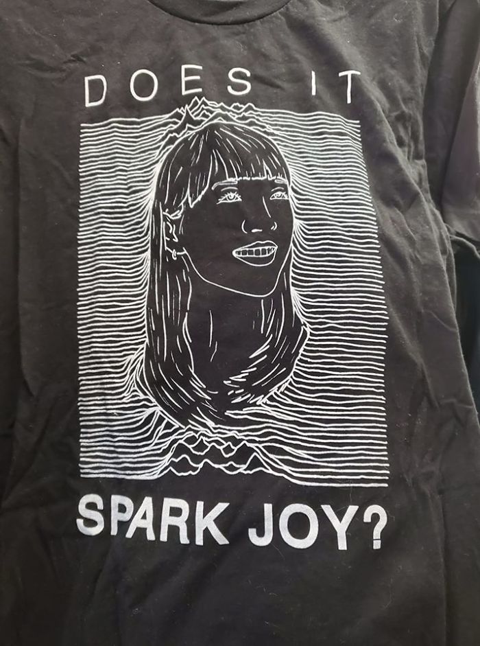 Found This Cross Between The Famous Joy Division Shirt And Marie Kondo. It Was $1.99 And While I Held It For About 10 Minutes While I Looked At Other Things, It Just Did Not Spark Any Joy In Me To Entice Me To Bring It Home
