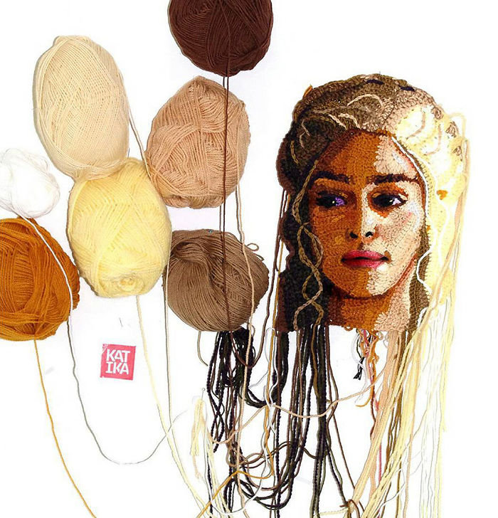 Crochet artist creating a detailed portrait using various shades of yarn, showcasing skill in textile art.