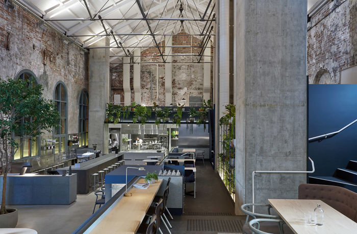 Former Power Station Converted Into An Industrial Cafe And Restaurant With Exposed Brickwork And Abundant Planting In Melbourne, Australia