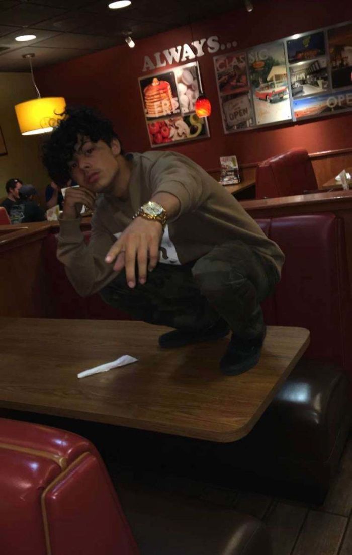 Squatting On A Restaurant Table For A Picture