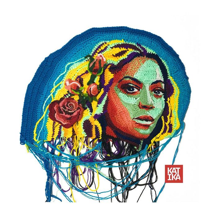 Crochet portrait of a woman with colorful hair and roses, showcasing unique crochet art and vibrant yarn details.