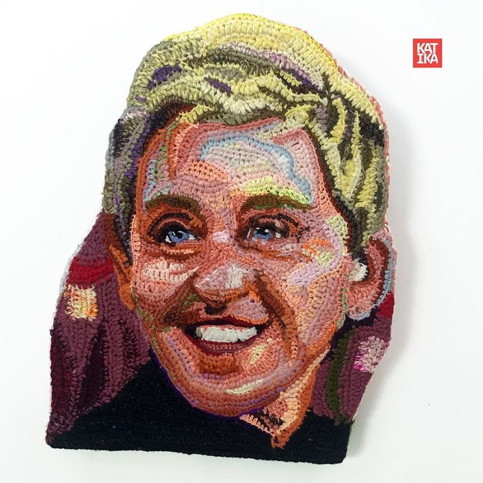 Crochet artist portrait featuring a colorful, textured face created with detailed yarn work on fabric background.